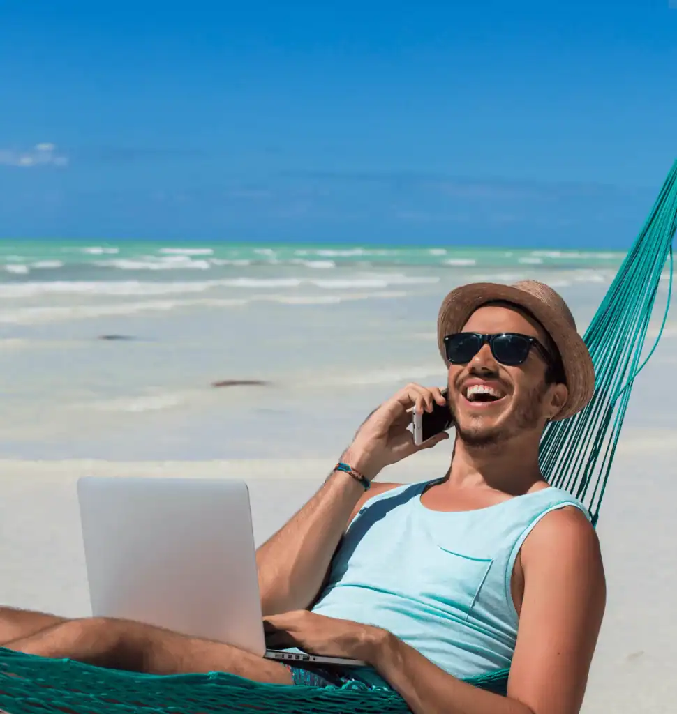 Man relaxing on the beach using portable WiFi device in Morocco.