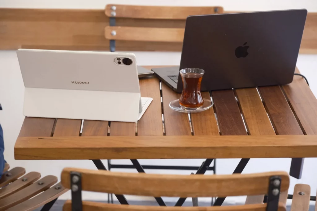 Laptop and coffee on a cafe table