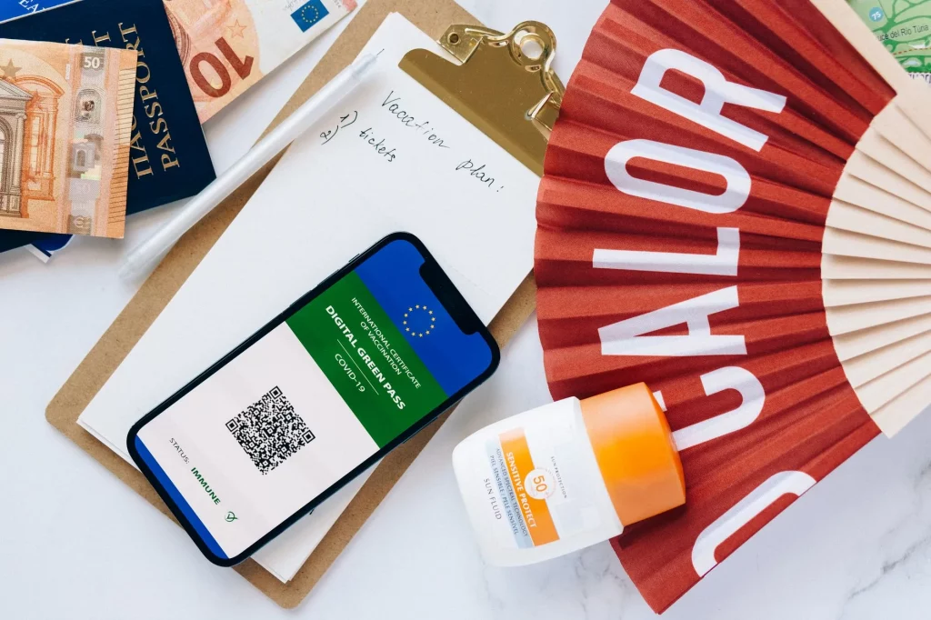 Smartphone and notebook laid out for travel planning