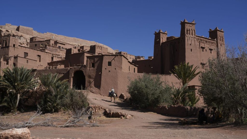 Stunning view of traditional kasbah architecture in Ouarzazate, Morocco, under clear blue skies.