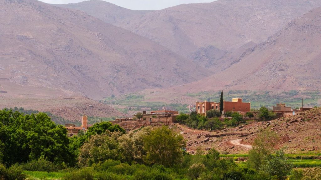 Explore the vibrant greens and rugged terrain of Morocco's Atlas Mountains.
