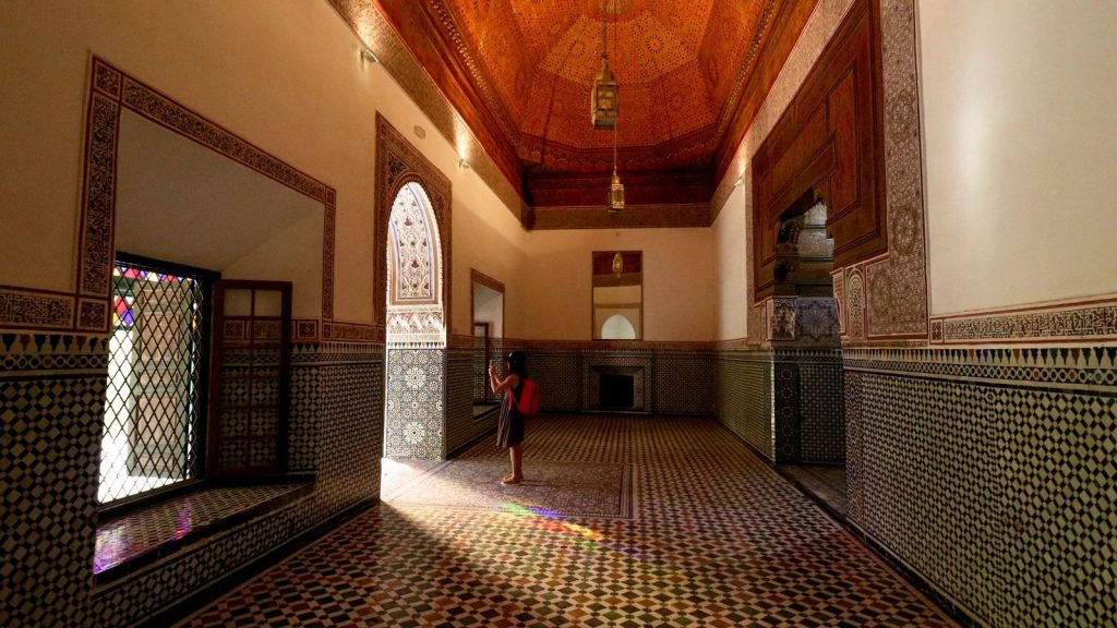 Tiled hall with a painted wooden ceiling and stained-glass windows in the Bahia Palace, Marrakech