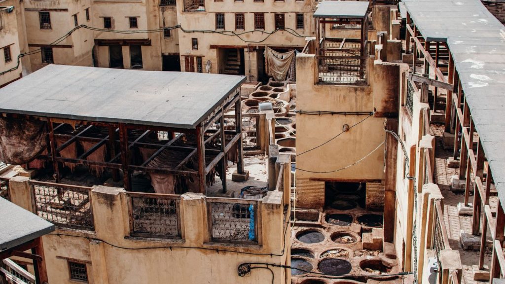 Aerial view of Chouara Tannery in the old town of Fes, Morocco showcasing traditional tanning pits.