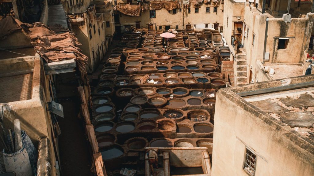 Explore the iconic Chouara Tannery in Fes, Morocco, showcasing traditional leather tanning methods from above.