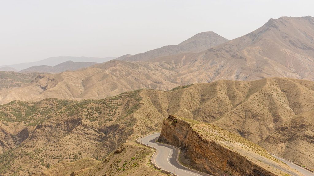 Winding road traversing the rugged Atlas Mountains in Marrakech, Morocco.