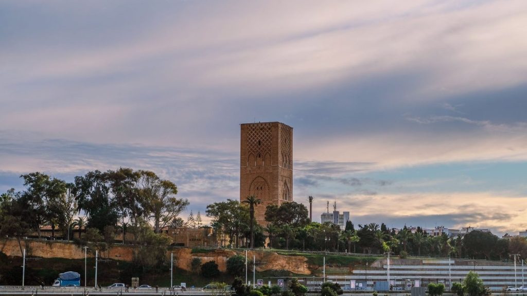 Hassan Tower in Rabat, Morocco, under dramatic evening skies. Iconic landmark.