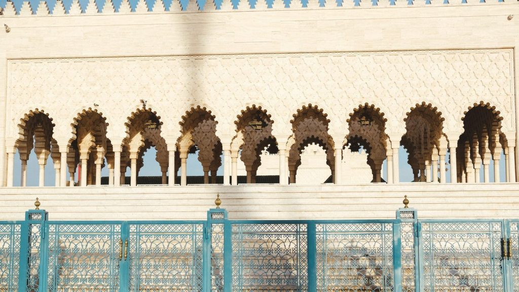 Stunning view of Hassan Tower's intricate arches and blue gates in Rabat, Morocco.