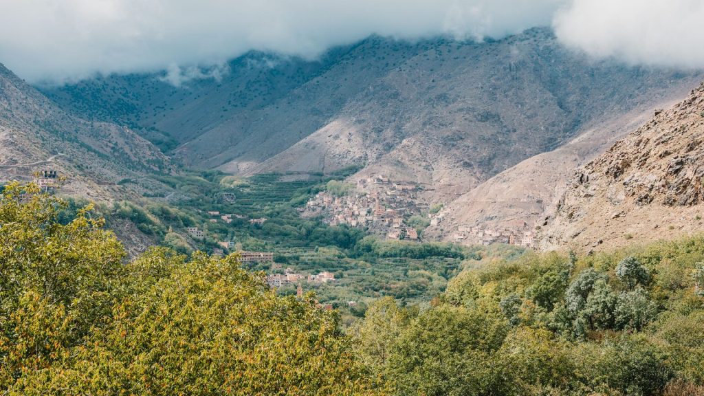 Scenic aerial view of Toubkal Valley in Morocco with lush greenery and mountains.