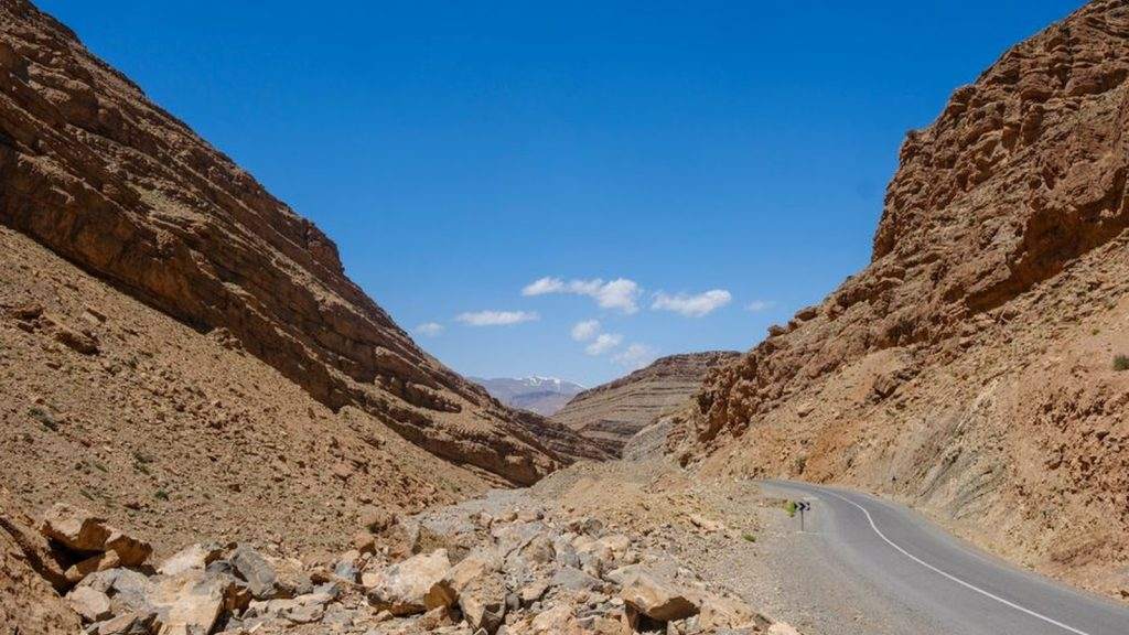Empty road winding through a rocky gorge in the Moroccan Atlas Mountains