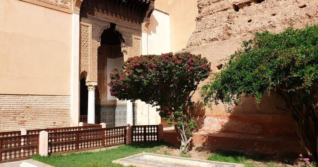 A garden courtyard with a flowering tree beside the Saadian Tombs in Marrakech